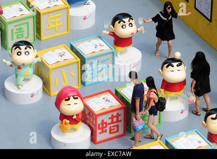 Shenyang. 11 Luglio, 2015. I cittadini di visitare una mostra nel XXV anniversario del manga giapponese serie Crayon Shin-chan a Shenyang, a nord-est della Cina di Provincia di Liaoning Luglio 11, 2015. Decine di manga e versione teatrale di Crayon Shin-chan e relative figure venivano visualizzati sulla mostra che ha aperto al pubblico il sabato. © Xinhua/Alamy Live News Foto Stock