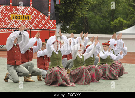 Riga, Lettonia. 11 Luglio, 2015. Scolari danza nella formazione come essi partecipano in un folk-spettacolo di danza come parte della scuola di canto e danza Festival in Riga, capitale della Lettonia, il 11 luglio 2015. In costumi tradizionali tipici di ogni regione della Lettonia, scolari provenienti da tutto il paese Baltico riuniti nella capitale Riga di questa settimana per la scuola di canto e danza Festival. © Guo Qun/Xinhua/Alamy Live News Foto Stock