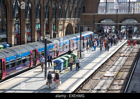 Persone di lasciare il treno alla stazione ferroviaria di King's Cross - Londra, Inghilterra Foto Stock