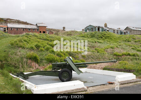 Ordnance QF 17-pounder campo di pistola a Fort Dunree County Donegal Irlanda con abbandonati edifici militari in background. Foto Stock