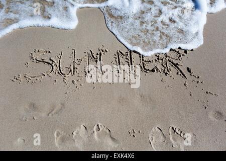 Iscrizione sulla spiaggia di sabbia. Riva del mare vicino con l'iscrizione. Estate Foto Stock