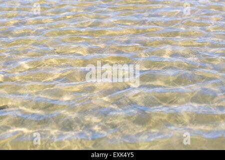 Sfondo astratto di ondulazioni sulla superficie dell'acqua sulla riva del mare. Bella naturale sfondo astratto Foto Stock