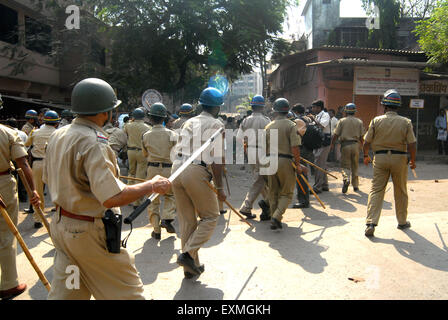 Il personale di polizia pattuglia rivoltosi rottura vetri veicoli Bhandup comunità Dalit resort violente proteste Mumbai Foto Stock