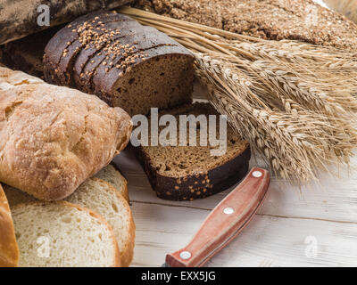 Il pane e il grano sulla scrivania in legno. Foto Stock