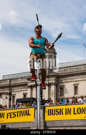 Londra, 18 luglio 2015. Unicyclist canadese e giocoliere 'Dynamike" intrattiene la Folla a Trafalgar Square come parte del Busk a Londra Festival volto a mostrare le straordinarie doti di molti della capitale i migliori artisti di strada, compresi, musicisti, maghi, statue viventi e bande. Credito: Paolo Davey/Alamy Live News Foto Stock