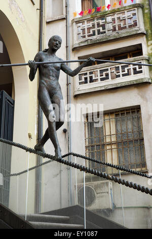 La scultura in bronzo di acrobat femmina su scale. Foto Stock