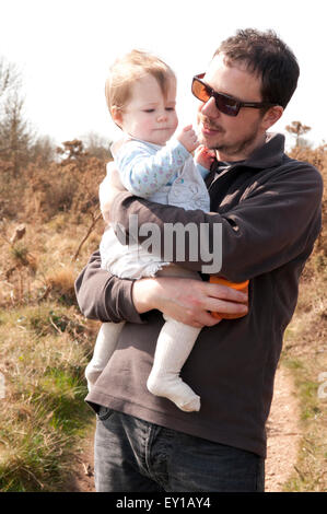Padre cuddling Baby girl Foto Stock