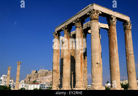 Grecia, Atene, tempio di Zeus Olimpio con l'Acropoli sullo sfondo Foto Stock