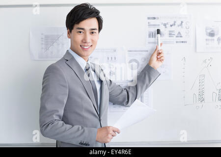 Giovane imprenditore puntando la lavagna in office Foto Stock