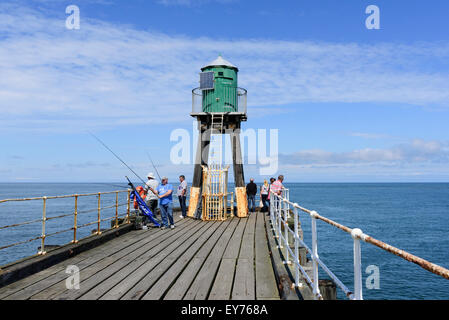 I pescatori sul molo Ovest Whitby Foto Stock
