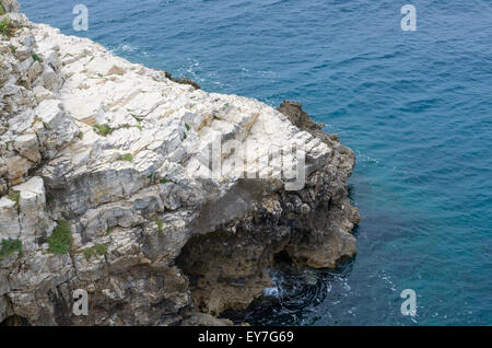 Costa rocciosa che si estende verso il mare Foto Stock