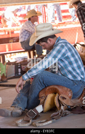 Il Wyoming, STATI UNITI D'AMERICA. 23 Luglio, 2015. Un professional rodeo cowboy si prepara a competere in Cheyenne Frontier Days rodeo eventi al Parco di frontiera Arena Luglio 23, 2015 in Cheyenne Wyoming. Giorni di frontiera celebra le tradizioni del cowboy del west con un rodeo, parata e fiera. Foto Stock