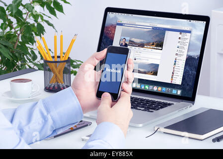 Varna, Bulgaria - 29 Maggio 2015: Facebook app su iPhone di Apple display e la versione desktop di Facebook su Apple Macbook Pro. Foto Stock