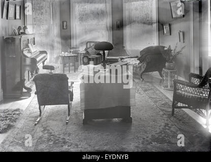 Antique c1910 fotografia di un tardo Vittoriano, circa 1910s Salone con pianoforte verticale e arredi. Vedere Alamy numero immagine EYDNYH per una vista alternativa di questa camera. Posizione sconosciuta, probabilmente il Massachusetts New England, STATI UNITI D'AMERICA. Foto Stock