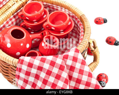 Wooden basket with red white speckles dish for background use Foto Stock