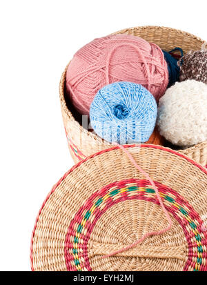 Yarns in basket on white background Foto Stock
