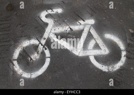 Dipinto di bianco di segno della bicicletta su asfalto nero media su strada strada per biciclette Foto Stock