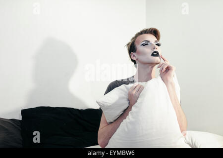 Maschio di drag queen in posa per pin-up stile ritratto glamour a casa.