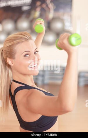 Bella bionda donna facendo esercizi di fitness Foto Stock