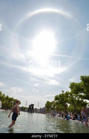 Un sun alo fenomeno è visto sopra la piscina e KAWS scultura in piazza Museumplein, Amsterdam Paesi Bassi il 16 Luglio 2015 Foto Stock