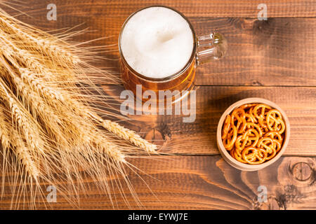 Oktoberfest boccale di birra e il tradizionale tedesco pretzel con coni di grano sulla tavola di legno Foto Stock