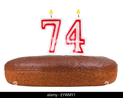 Torta di compleanno con il numero di candele 74 isolato su sfondo bianco Foto Stock