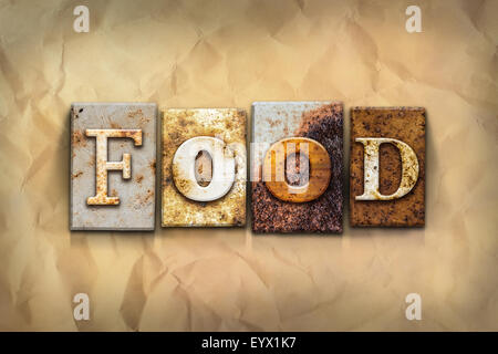 La parola "alimentare" scritta in metallo arrugginito rilievografia tipo su una sbriciolato invecchiato lo sfondo della carta. Foto Stock