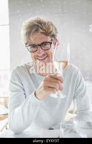 Ritratto uomo sorridente di bere il vino bianco Foto Stock