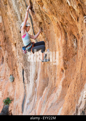 Razza mista ragazza arrampicata su parete di roccia Foto Stock