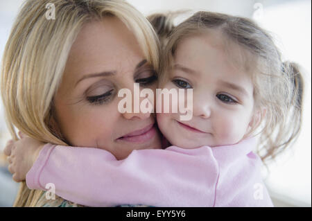 Close up di madre caucasica abbracciando la figlia Foto Stock