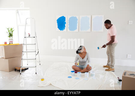 Giovane esaminando campioni di vernice nella nuova casa Foto Stock