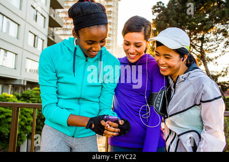 Guide di scorrimento utilizzando il cellulare in città Foto Stock