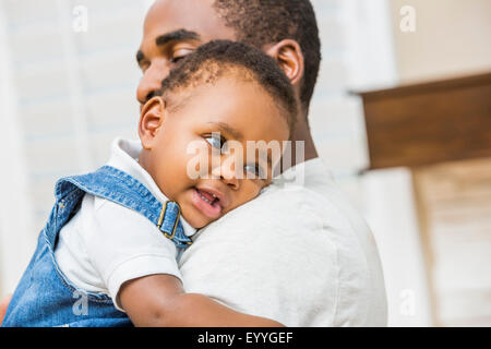 Close up nero azienda padre figlio bambino Foto Stock