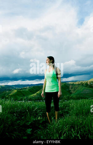 Razza mista atleta in piedi sulla collina rurale Foto Stock