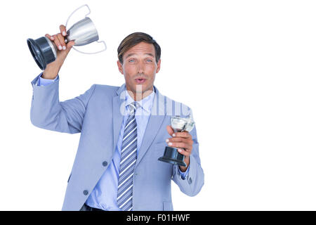 Happy businessman tenendo un trofeo Foto Stock