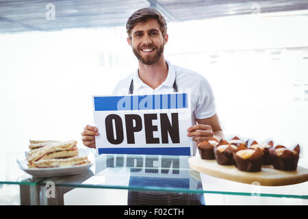 Lavoratore sorridente mettendo a segno aperto Foto Stock