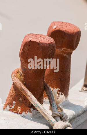 Vecchio di legno barca da pesca bitte con fune avvolta intorno. Close-up. Foto Stock