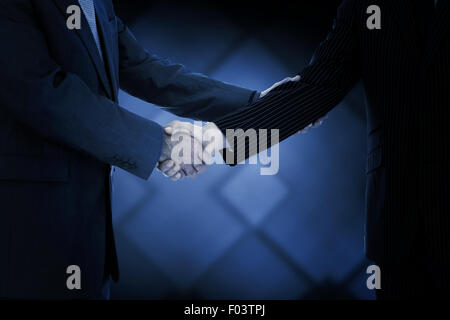 Immagine composita di handshake in accordo Foto Stock