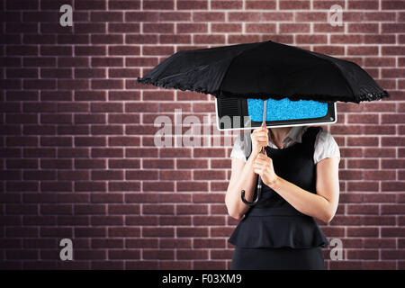 Immagine composita di pretty redhead imprenditrice azienda ombrello Foto Stock