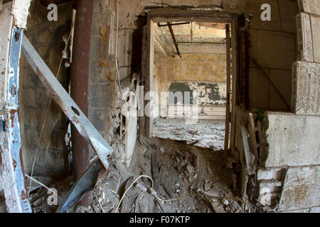 Decadendo interno dell edificio scolastico riempito con detriti. Foto Stock