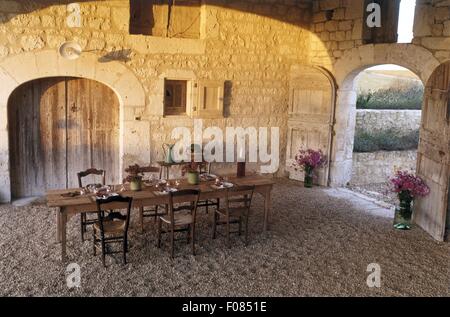 Di cui tavolo e sedie con decorazioni autunnali nel vecchio fienile Foto Stock