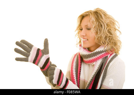 Sorridente donna bionda mettendo su guanti invernali Foto Stock