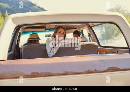 Giovane donna appoggiata contro backseat guardando fuori del raccoglitore della finestra carrello Foto Stock