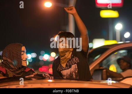 Ferguson, STATI UNITI D'AMERICA. 11 Ago, 2015. Un protestor è visto nel corso di una manifestazione in Ferguson, gli Stati Uniti, il 11 agosto, 2015. Le proteste dell'anniversario della ripresa di disarmato 18-anno-vecchio Michael Brown sono state estese per una seconda giornata di martedì in Ferguson. Lo stato di emergenza è stato dichiarato per la città di Ferguson il lunedì a seguito di scontri tra polizia e manifestanti domenica notte. Credito: Egli Xianfeng/Xinhua/Alamy Live News Foto Stock