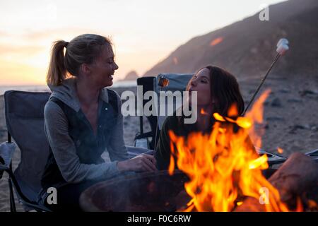 Fidanzate avente barbecue sulla spiaggia, Malibu, California, Stati Uniti d'America Foto Stock
