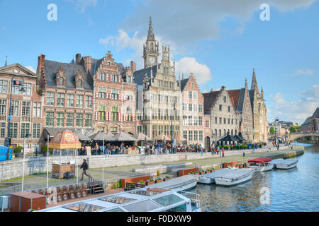 Bel canale di Gand con Imbarcazioni da fiume e palazzi medievali e un cielo blu chiaro Foto Stock