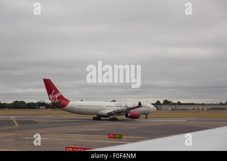 Virgin Atlantic aeroplani di rullaggio sulla pista all'aeroporto di Londra Heathrow Foto Stock