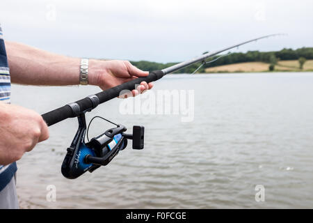 Uomo con asta di Pesca a Mosca Report di Pesca in un lago Foto Stock