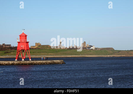 Priorato di Tynemouth e Collingwood Memorial a Tynemouth, Inghilterra. Mandria Groyne faro sorge sul fiume Tyne. Foto Stock