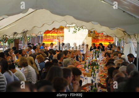 A Taizé, Francia. Il 16 agosto 2015. Lo speciale ha invitato gli ospiti hanno la cena insieme con i fratelli di Taizé nel giardino. I leader della Chiesa da diverse chiese cristiane come pure i rappresentanti delle religioni non cristiane hanno partecipato alla preghiera di rendimento di grazie in memoria di Frère Roger di Taizé in occasione del decimo anniversario della sua morte. Credito: Michael Debets/Alamy Live News Foto Stock